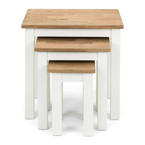 Set of three nesting tables with wooden tops and white bases on a white background