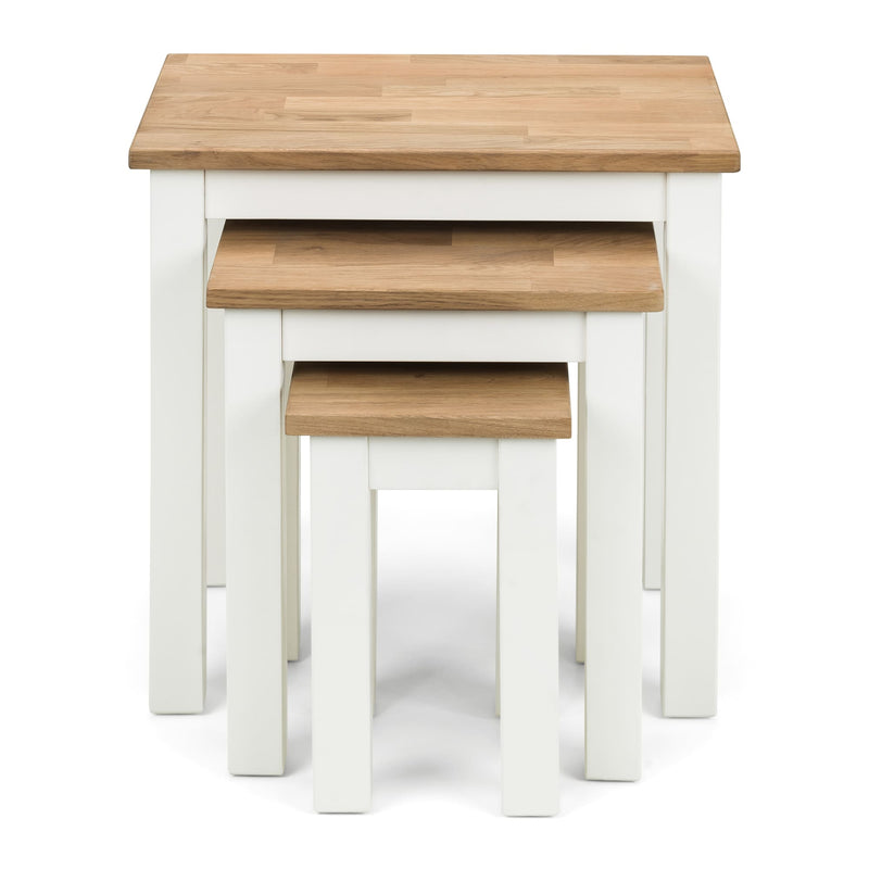 Set of three nesting tables with wooden tops and white bases on a white background