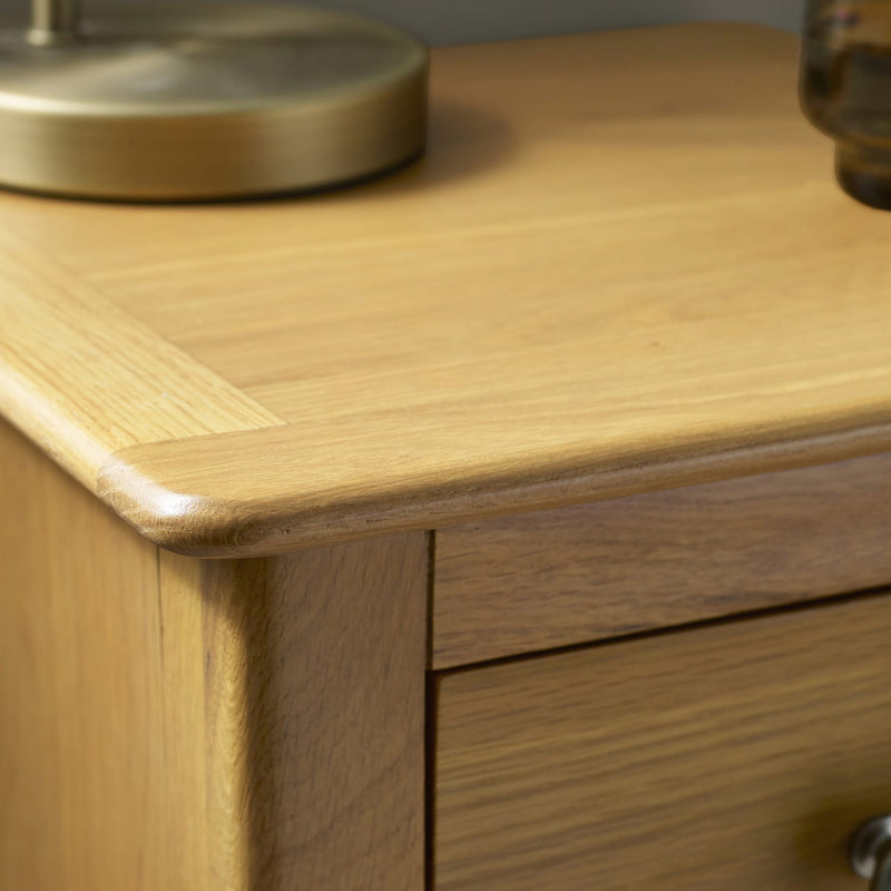 Close-up of a wooden cabinet with a lamp on top