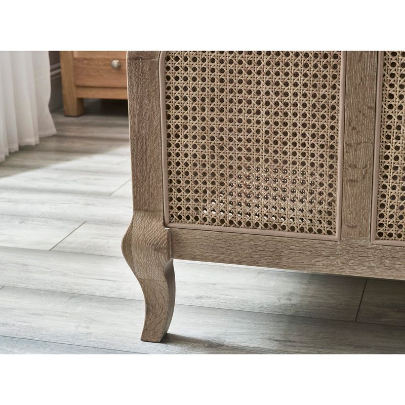 Wooden cabinet with wicker detailing on a wooden floor