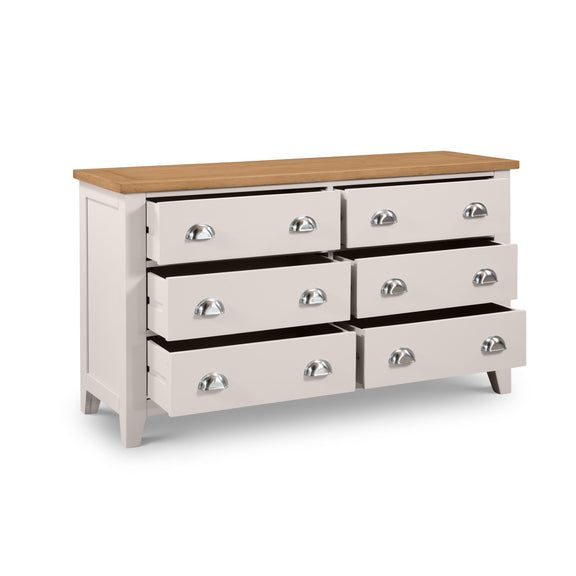 White dresser with six drawers and a wooden top on a white background
