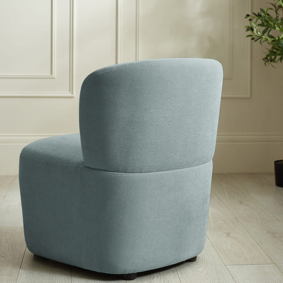 Gray armchair in a room with light-colored walls and wooden floor.