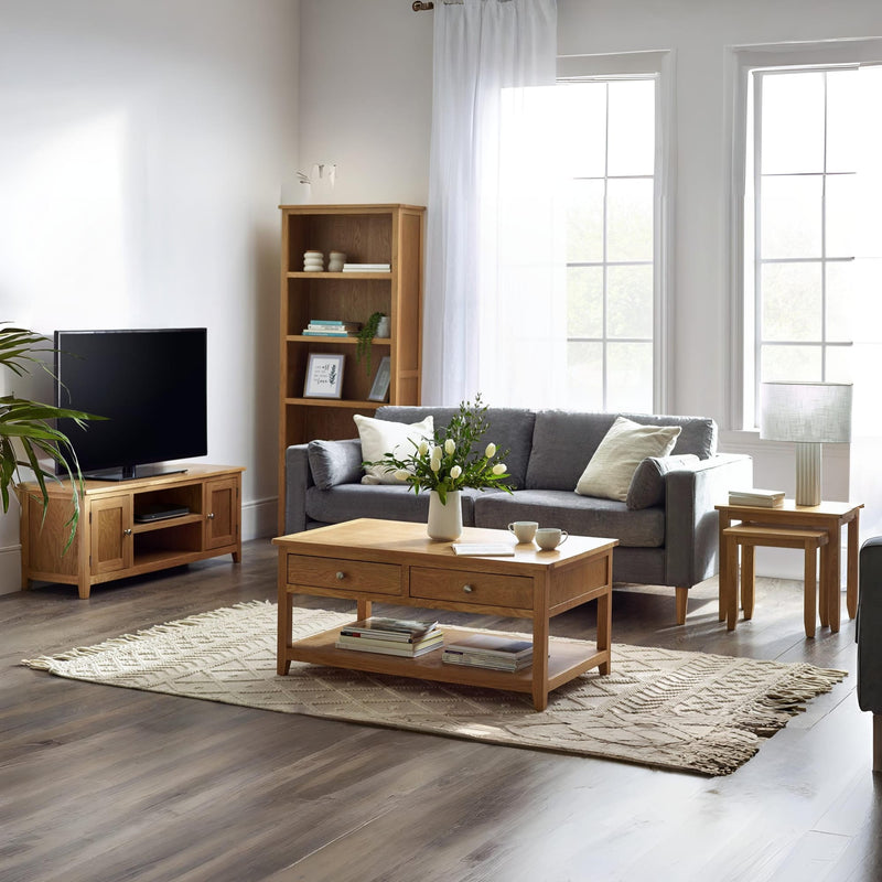 Living room with gray sofa, wooden coffee table, and bookshelf.