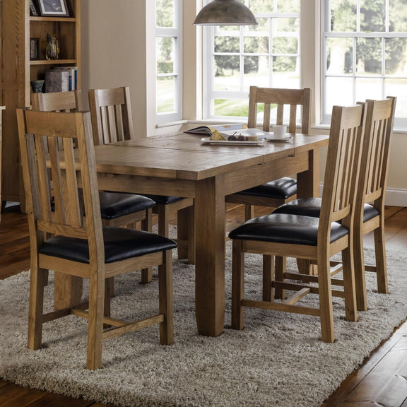 Dining room with wooden table and chairs on a rug