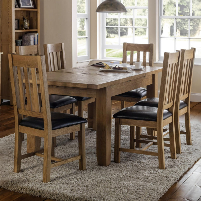 Dining room with wooden table and chairs on a rug