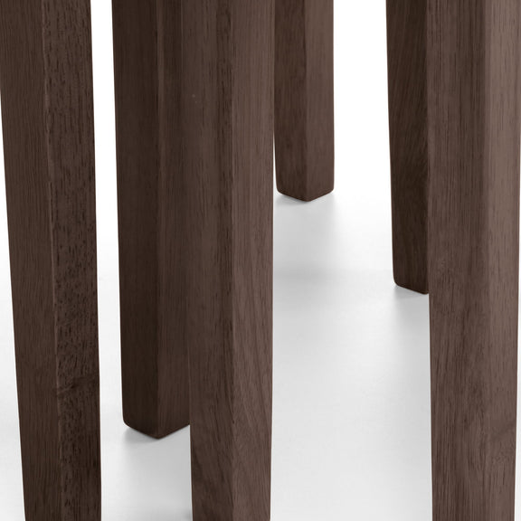 Close-up of dark wooden stools on a white background
