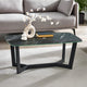 Coffee table with black marble top and black metal legs in a living room setting.