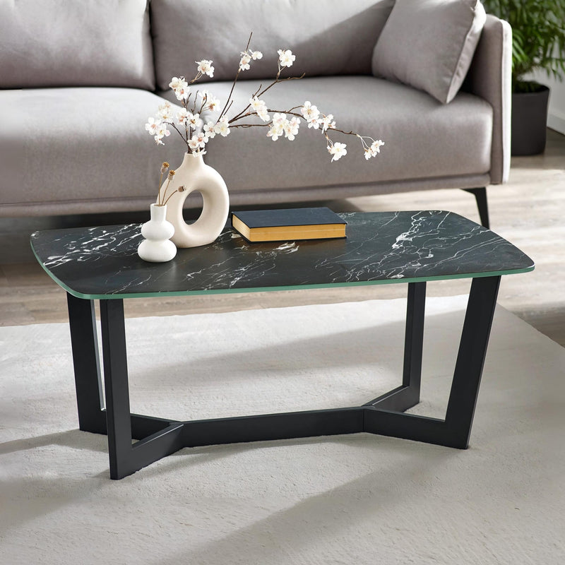 Coffee table with black marble top and black metal legs in a living room setting.