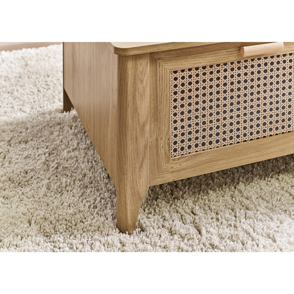 Wooden cabinet with wicker basket on a carpeted floor