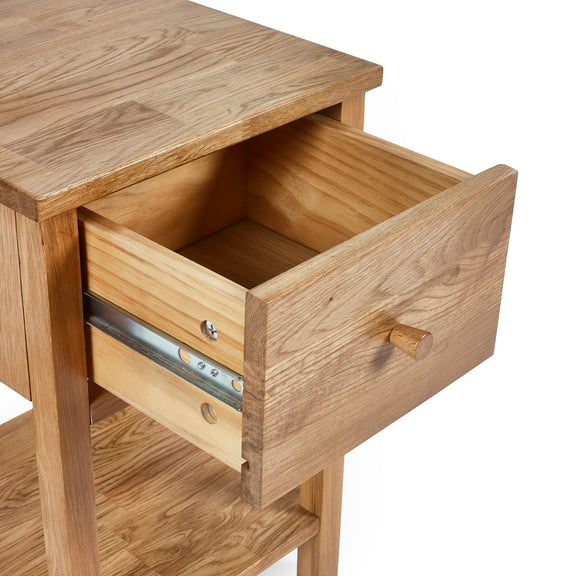Wooden side table with open drawer on a white background