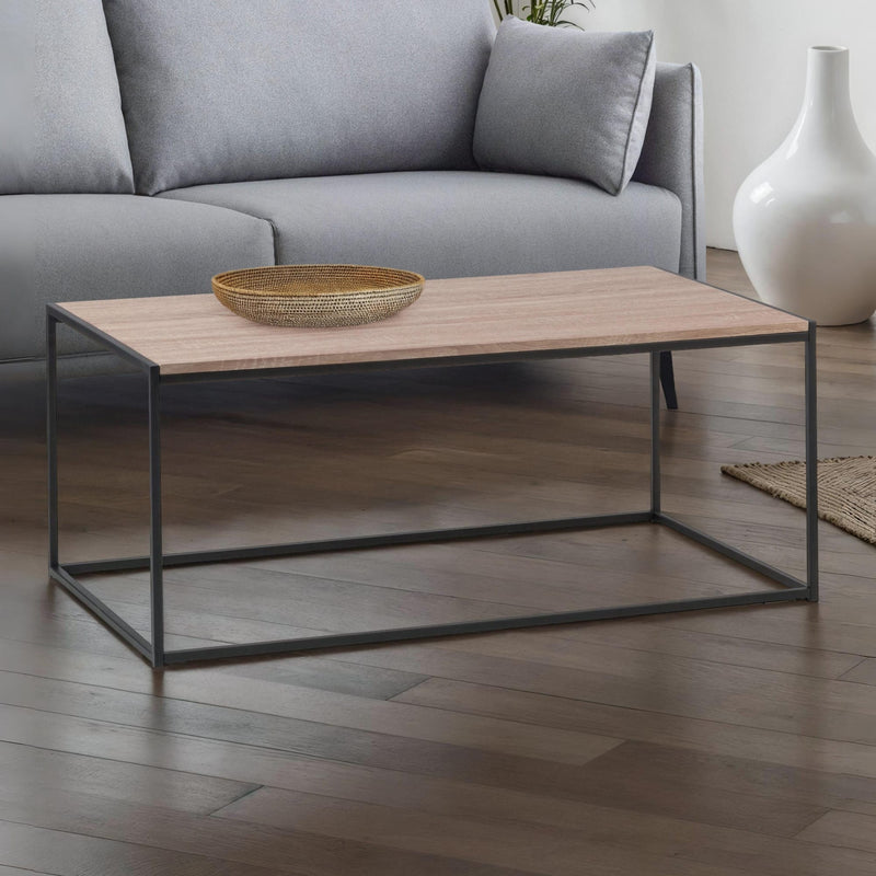 Wooden coffee table with metal legs in a living room setting.