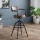 Brown bar stool with black metal frame in a room with plants and wooden floor.