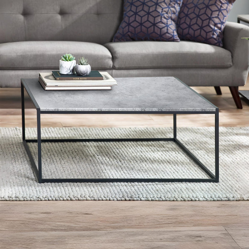 Coffee table with a gray marble top and black metal frame in a living room setting.