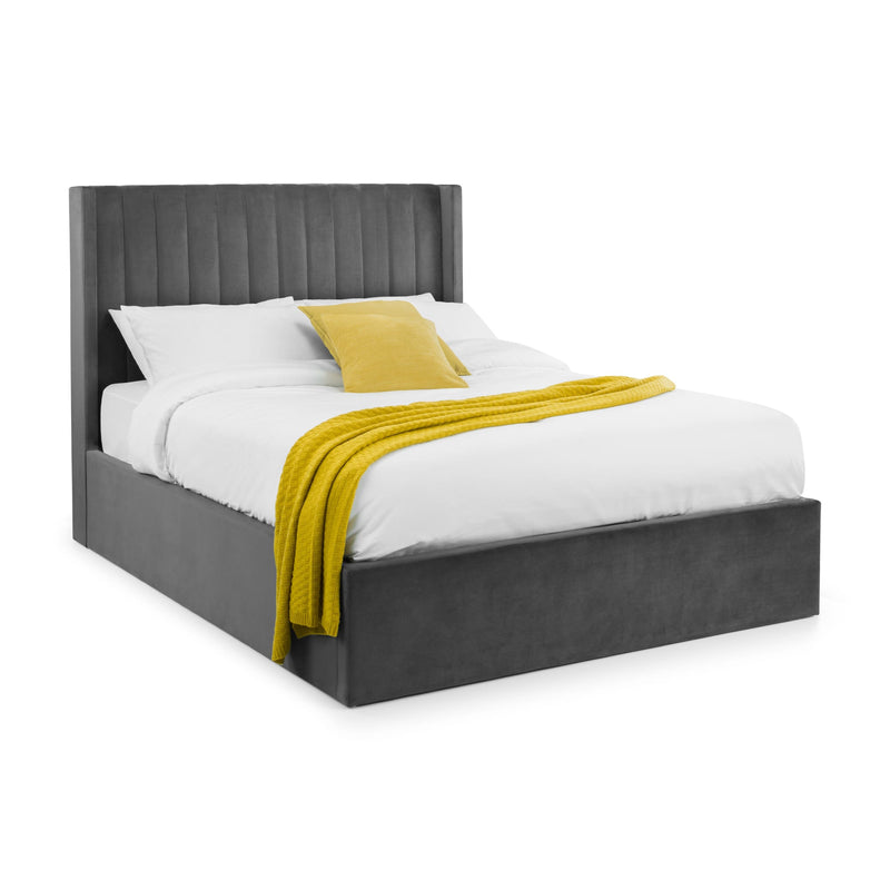 Bed with gray upholstered headboard and yellow blanket on a white background