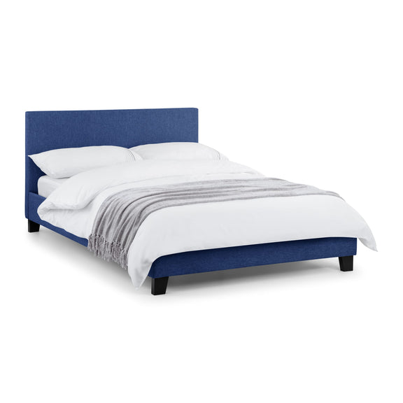 Gray upholstered bed with white bedding on a white background