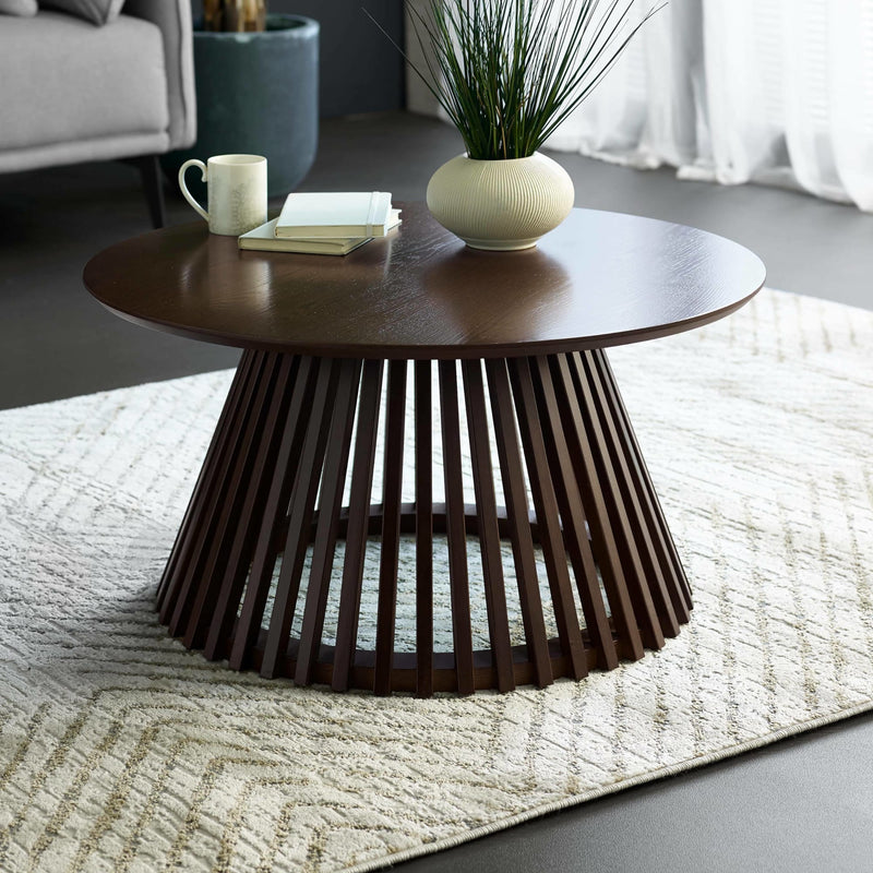 Wooden coffee table with a vase and mug in a living room setting