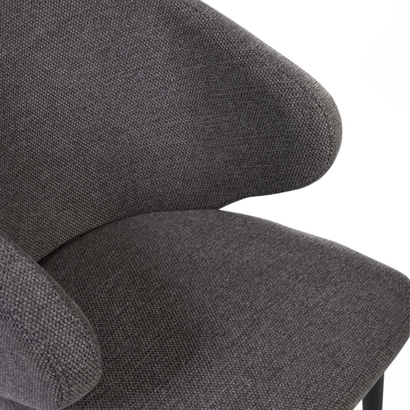 Close-up of a gray upholstered chair with a textured fabric finish.