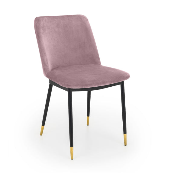 Pink velvet chair with black legs and gold foot caps on a white background
