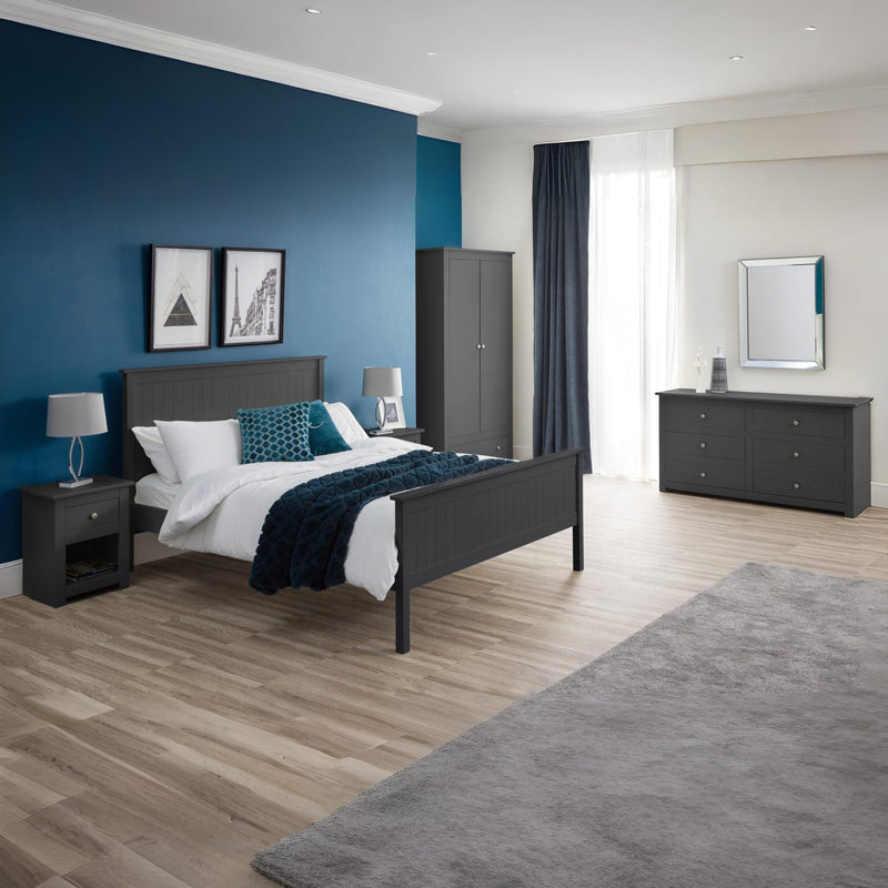Modern bedroom with dark gray furniture, blue walls, and wooden flooring.