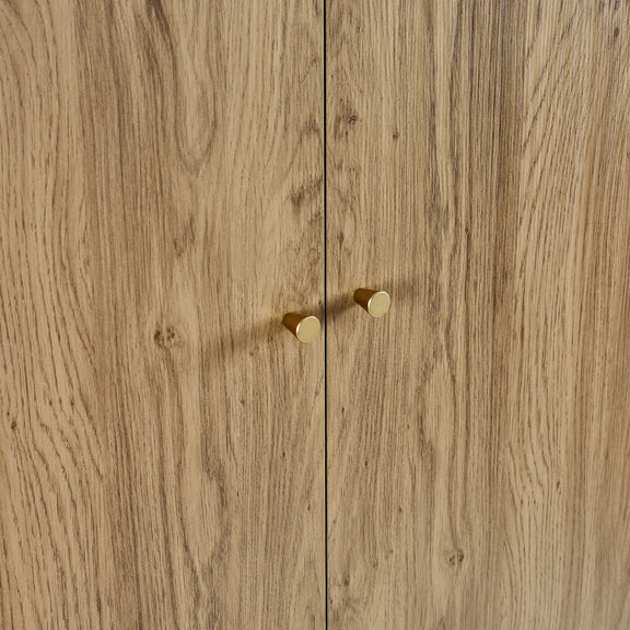 Wooden cabinet with two gold handles on a wooden background