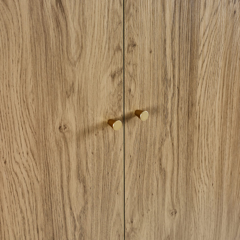 Wooden cabinet with two gold handles on a wooden background