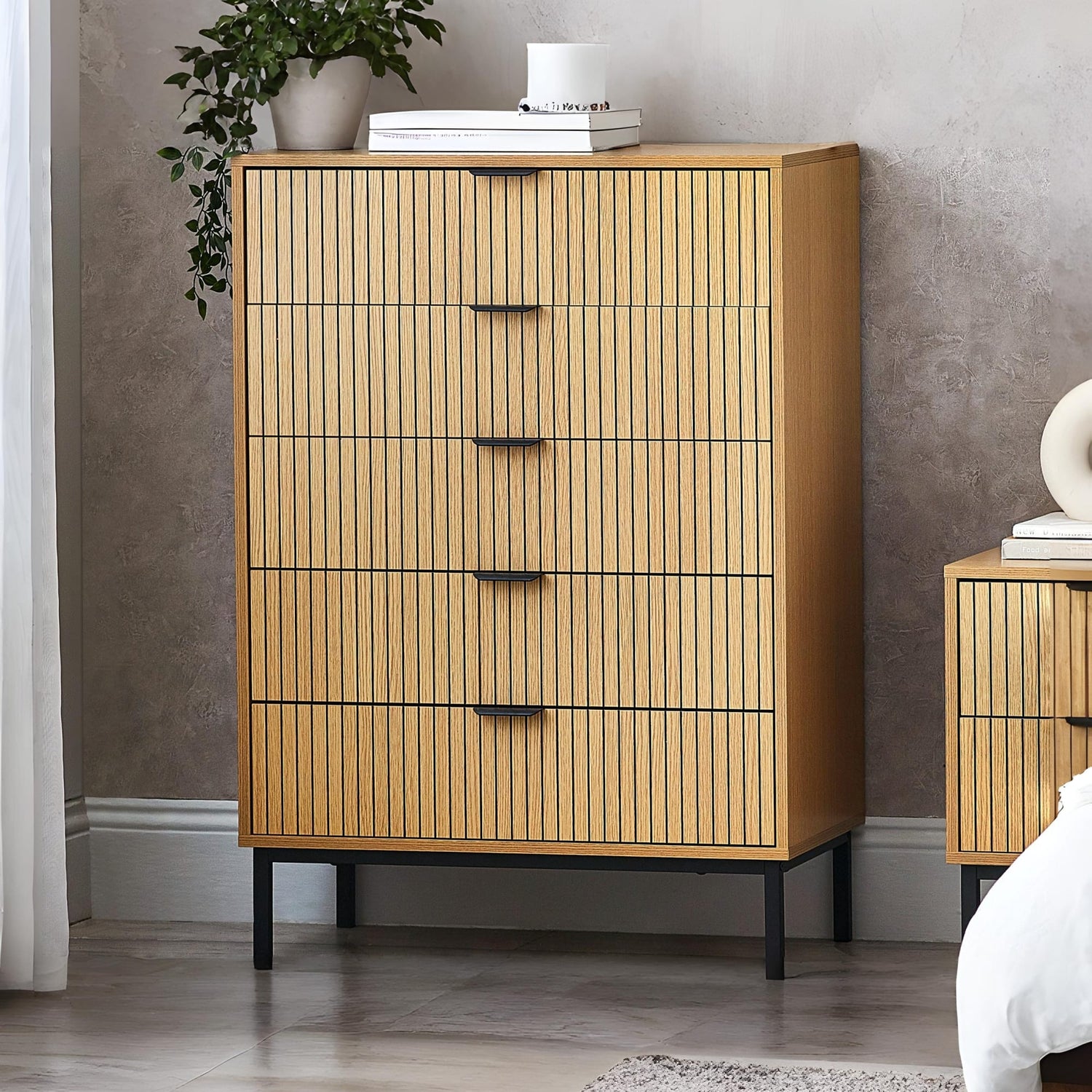 Wooden dresser with vertical slats in a bedroom setting