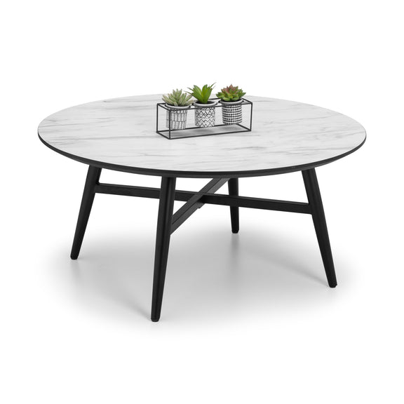 Round coffee table with white marble top and black metal legs on a white background