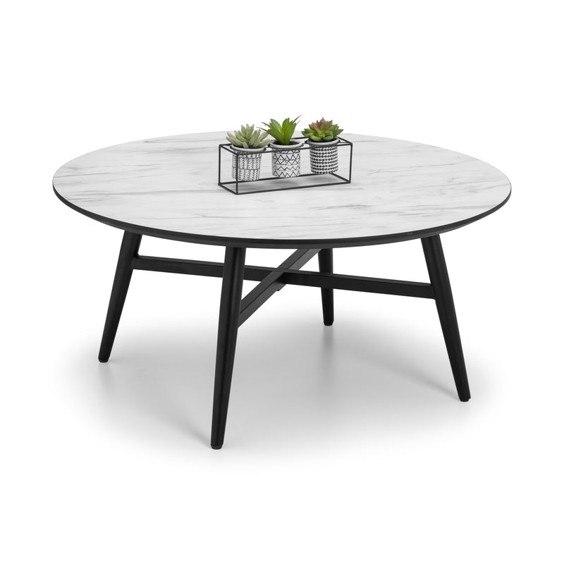 Round coffee table with white marble top and black metal legs on a white background