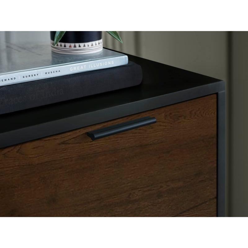 Dark wooden cabinet with a black handle and books on top