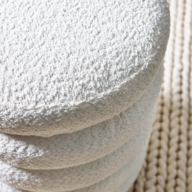 Stack of stone-like textured stones with a woven mat background