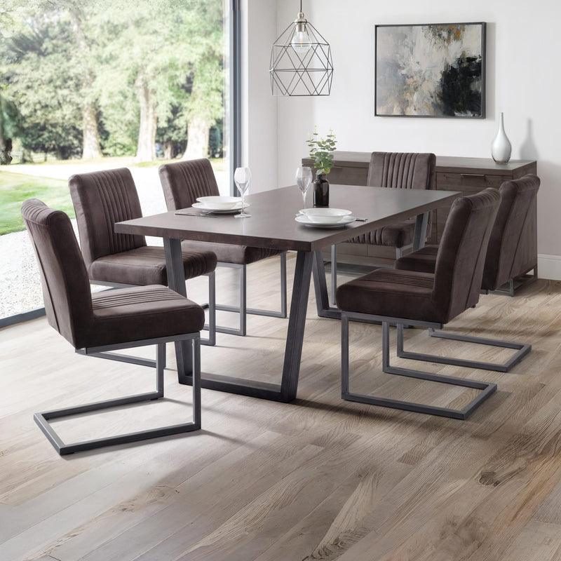 Dining room with a modern table and chairs in a well-lit room.