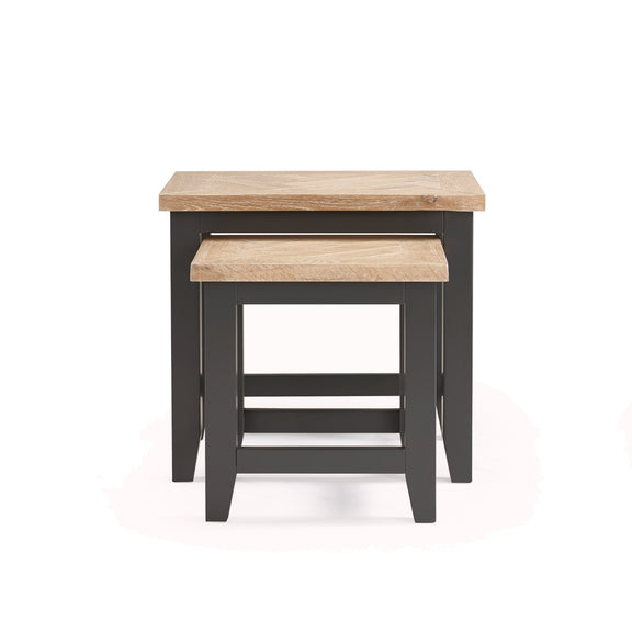 Set of two nesting tables with wooden tops and black bases on a white background