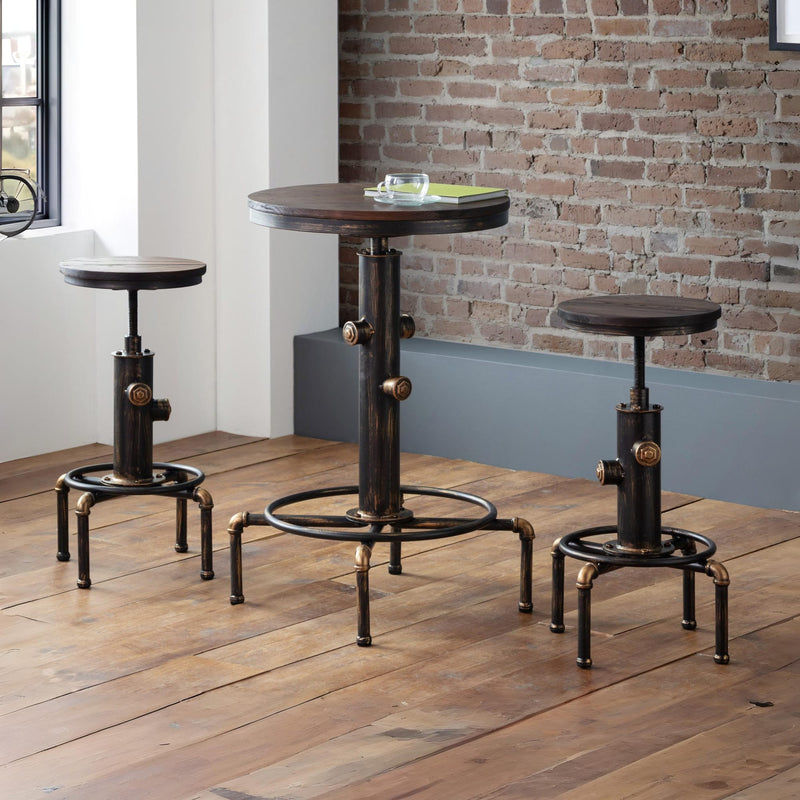 Set of industrial-style stools and a small round table on a wooden floor with a brick wall background.