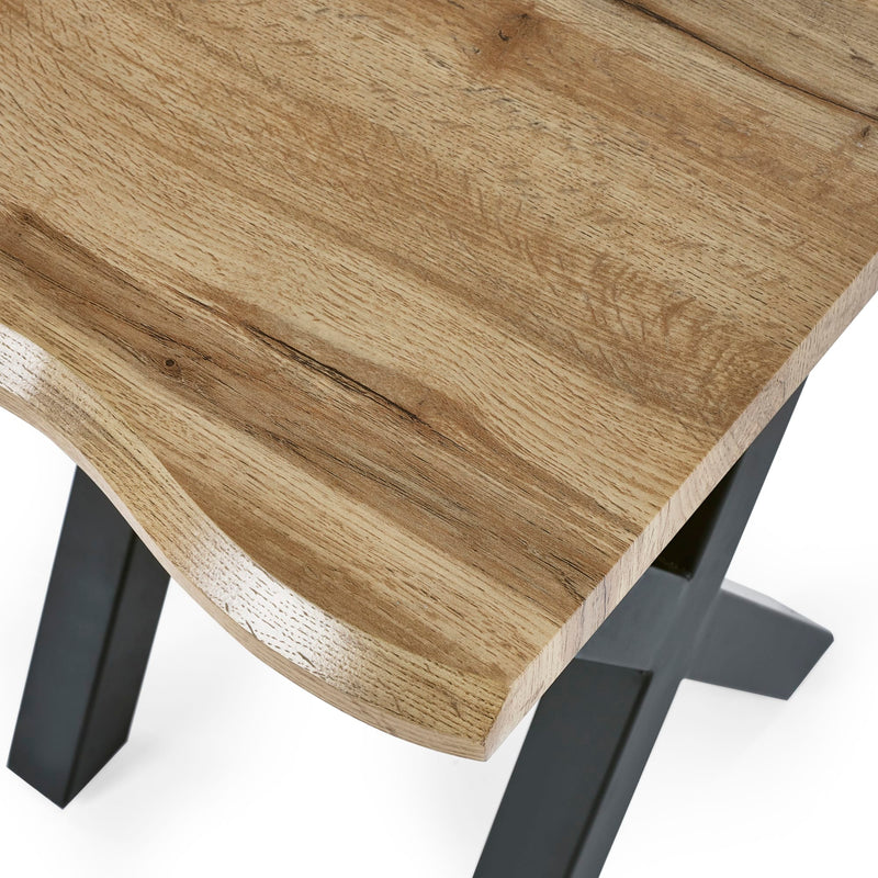Wooden table top with black metal legs on a white background