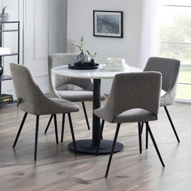 Dining room with a round table and four gray chairs.