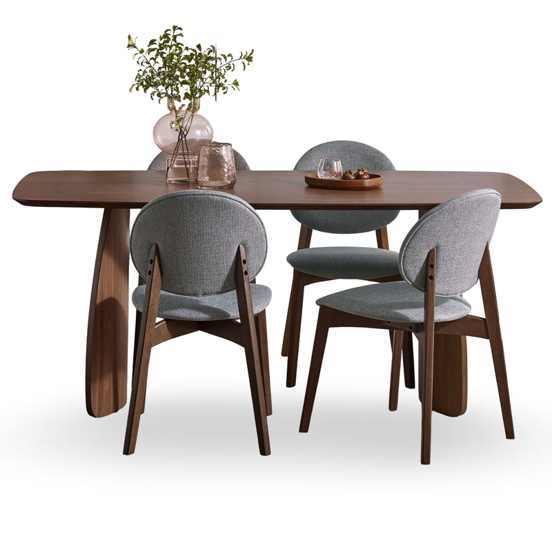 Dining table set with four chairs on a white background