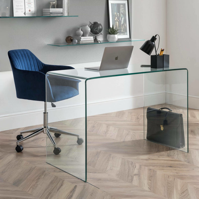 Modern office setup with a glass desk, blue chair, and laptop.