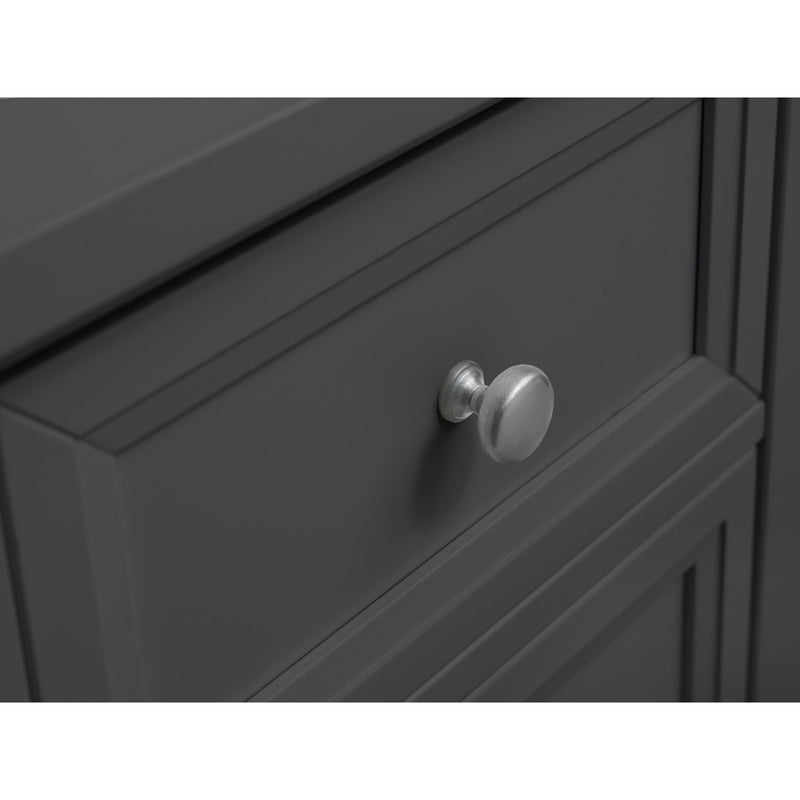 Close-up of a dark gray cabinet with a silver knob on a white background