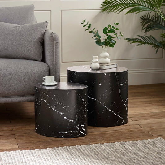 Black marble side tables in a living room setting with a gray sofa and decorative items.