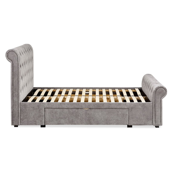 Gray upholstered bed with slatted frame on a white background