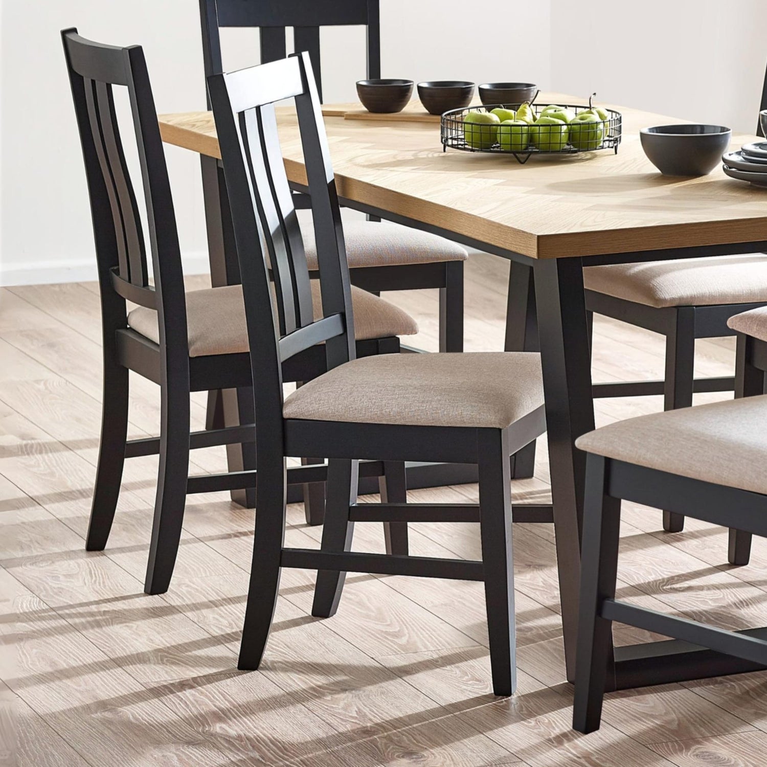 Dining table with black chairs on a wooden floor