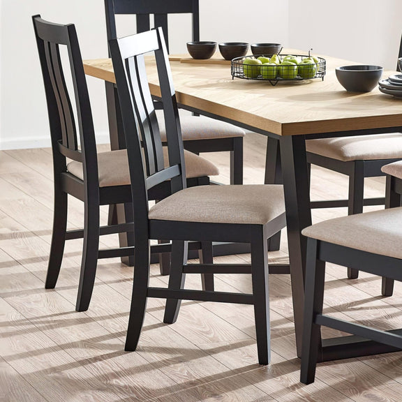 Dining table with black chairs on a wooden floor