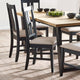 Dining table with black chairs on a wooden floor