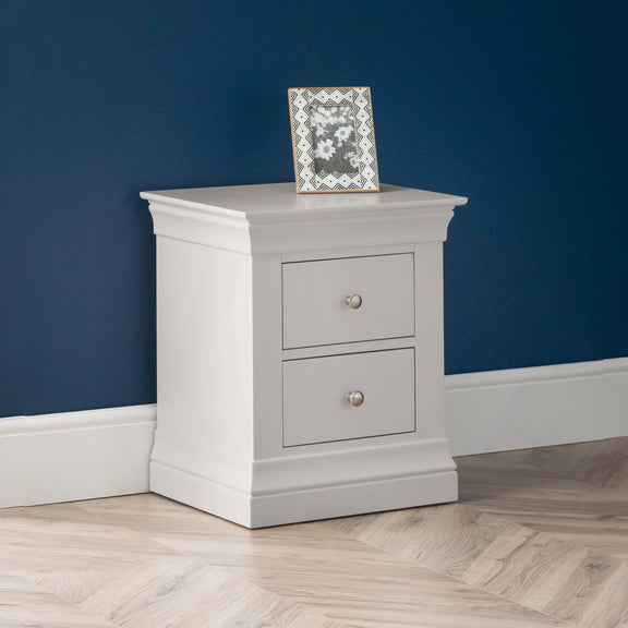 Gray nightstand with two drawers against a blue wall
