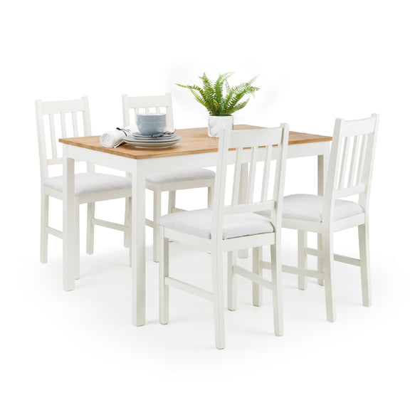 Dining table set with four white chairs on a white background