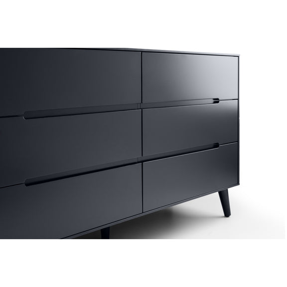 Dark gray dresser with four drawers on a white background