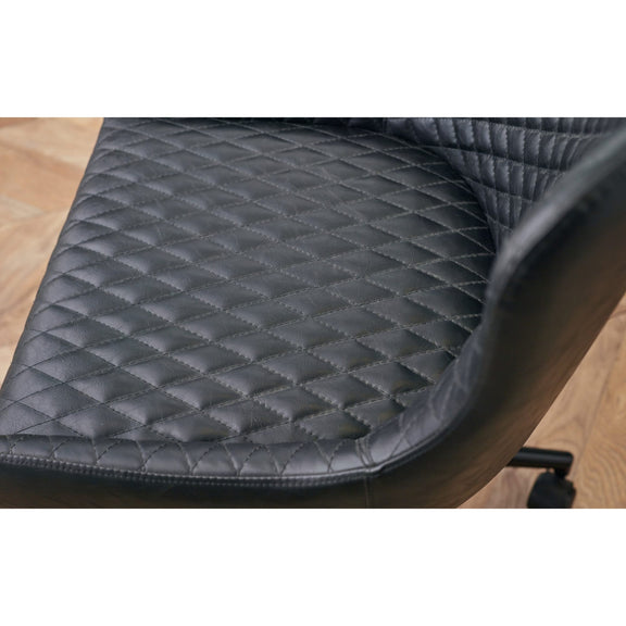 Quilted black chair pad on a wooden chair