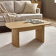 Wooden coffee table with a cup and books in a living room setting