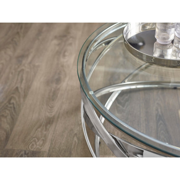 Glass coffee table with metal legs on a wooden floor