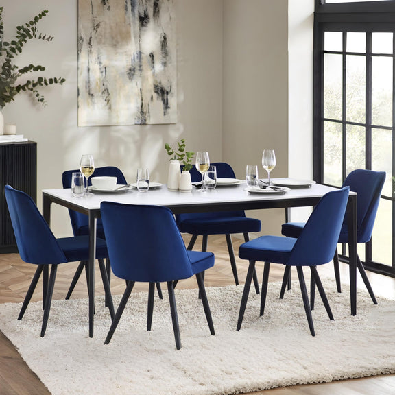 Dining room with a table and blue chairs in a well-lit room.